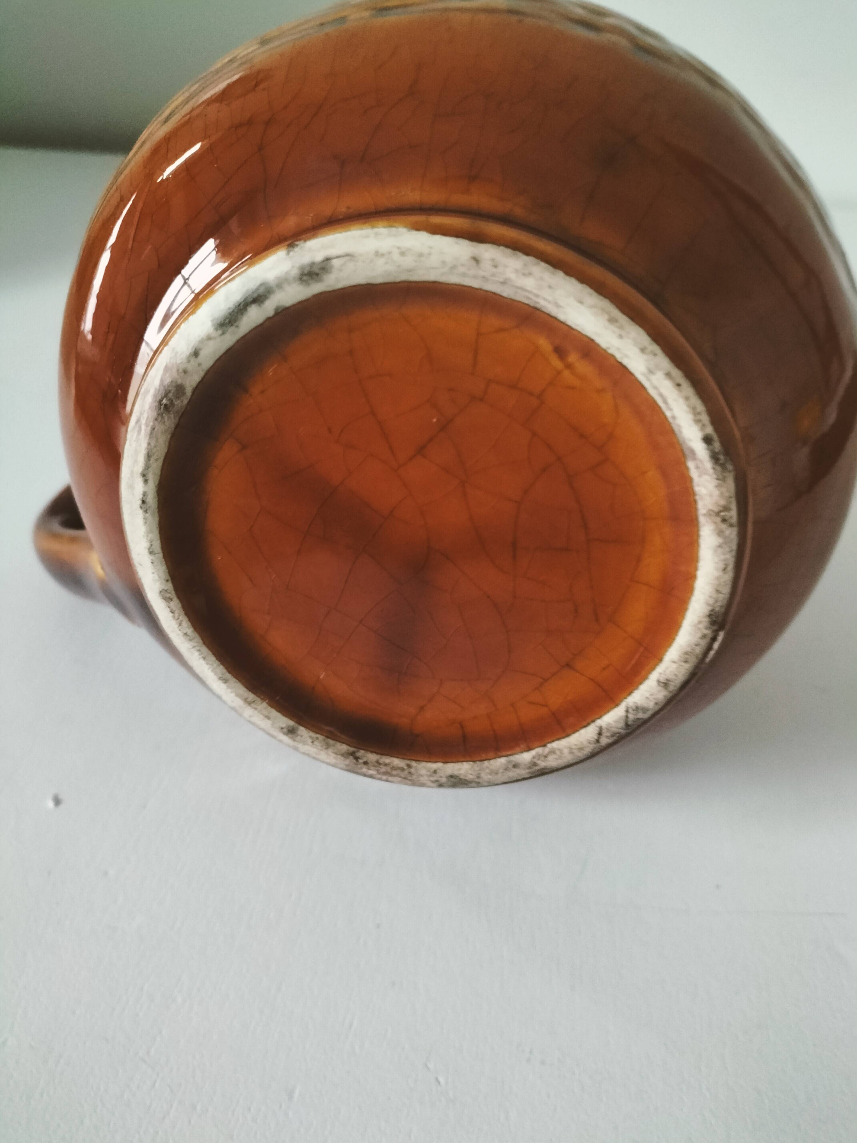 Caramel slipware pitcher with braided relief