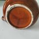 Caramel slipware pitcher with braided relief