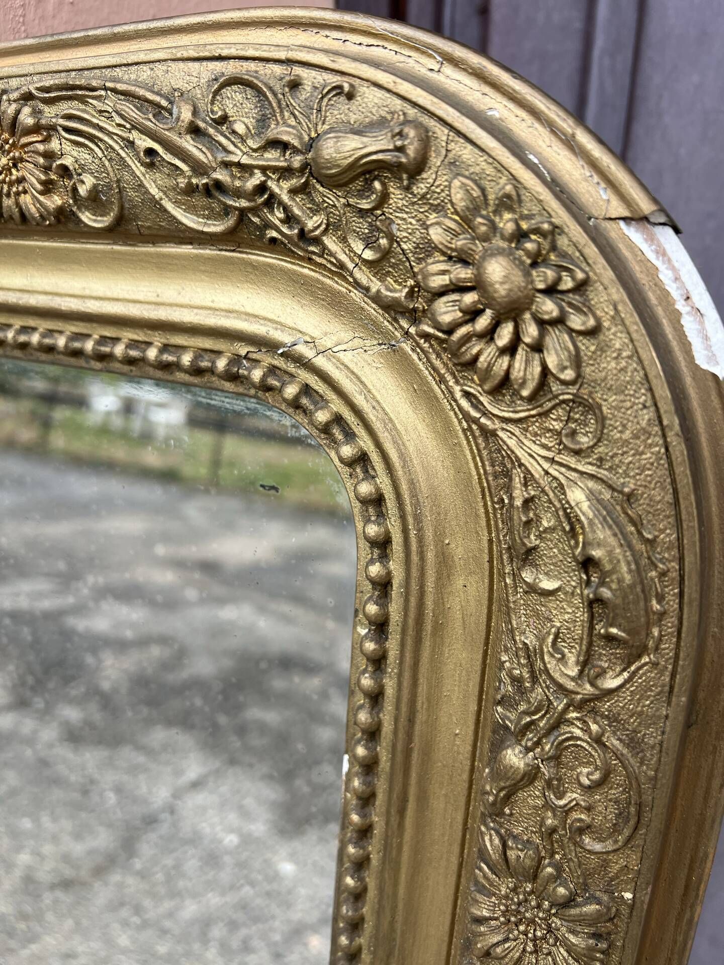 Large Louis Philippe mirror in carved gilded wood with mercury glass.