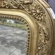 Large Louis Philippe mirror in carved gilded wood with mercury glass.