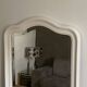Antique mirror with a gendarme hat shape. White. 72x56.