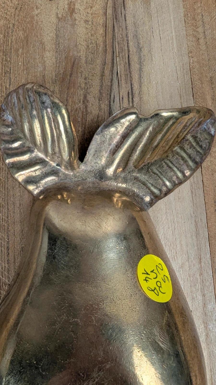 Small vintage brass trinket dish in the shape of a pear.
