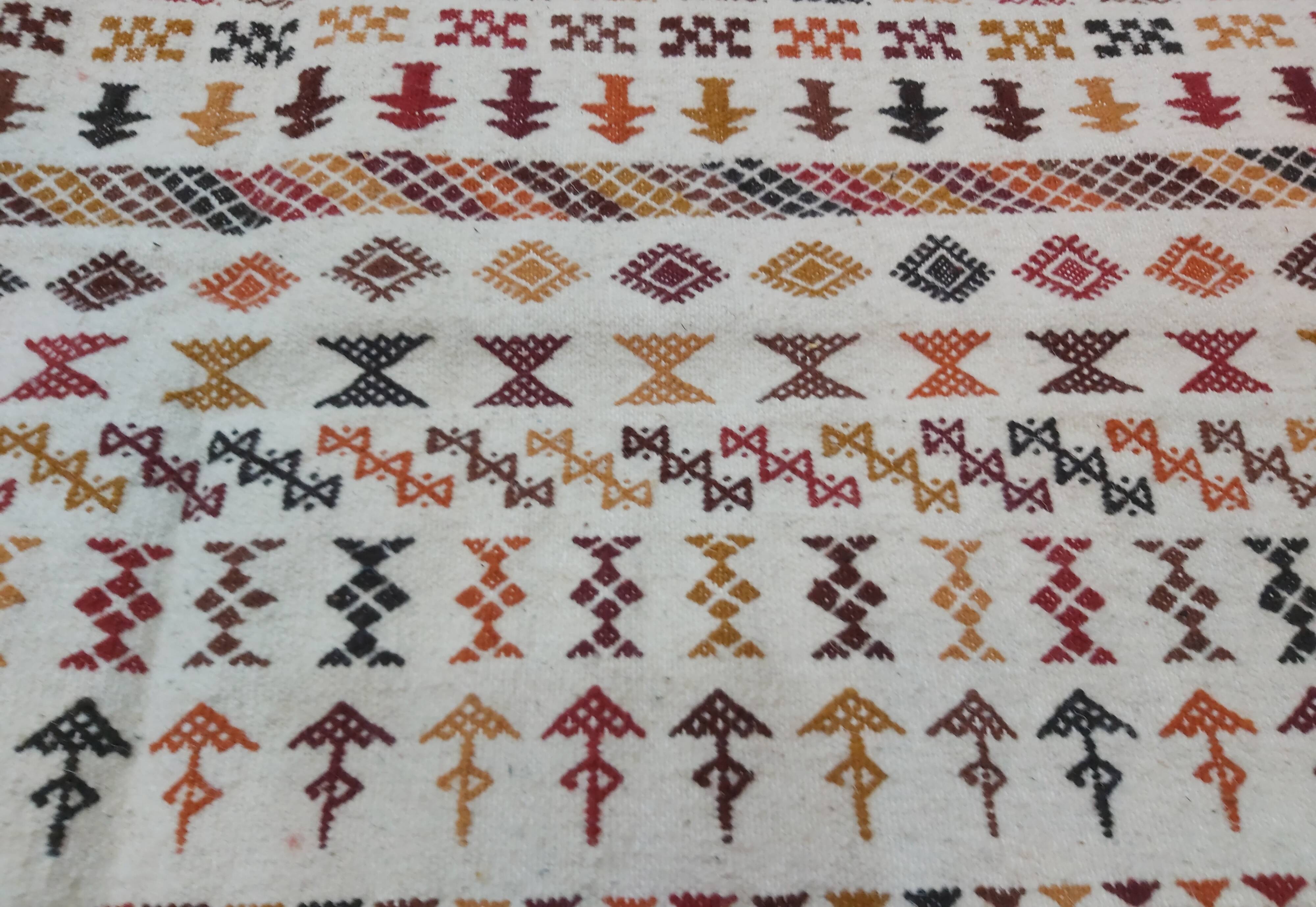 White carpet with multicolored Berber patterns