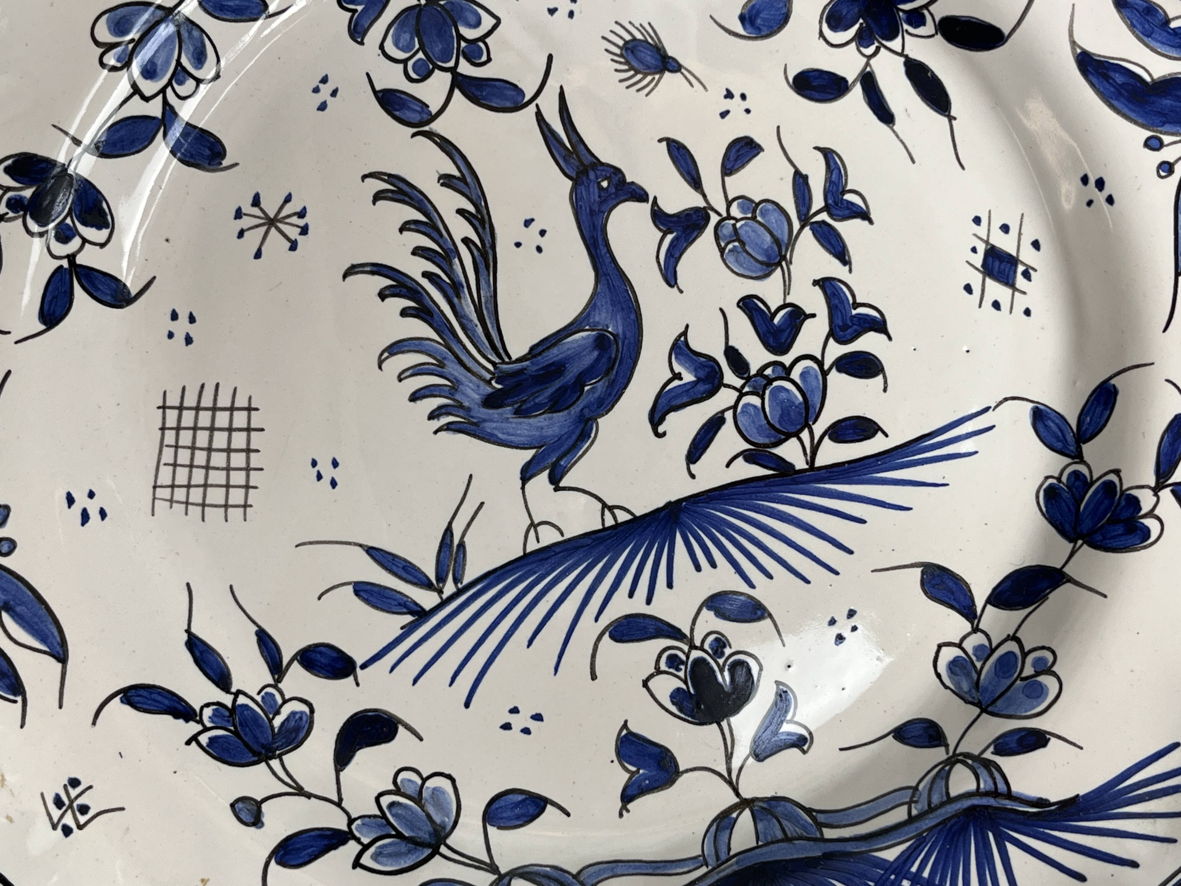 Moustiers, pairs of plates with wading bird design, scalloped edge, early 20th century.