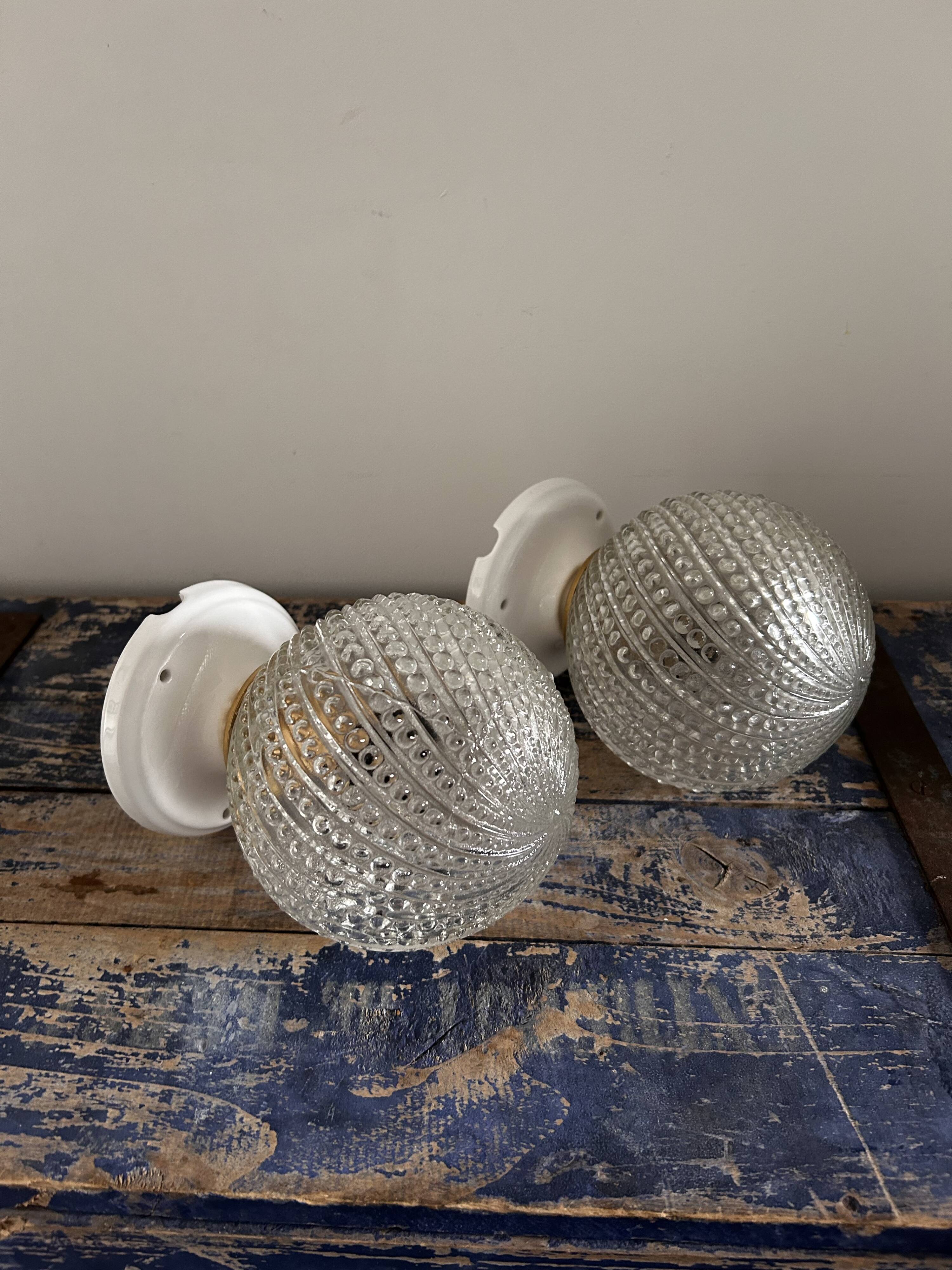 Set of two chiseled glass globe wall lights