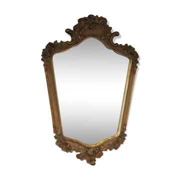 Antique mirror with gilded wooden frame and polychrome decoration.