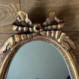 Old oval gilded stucco mirror