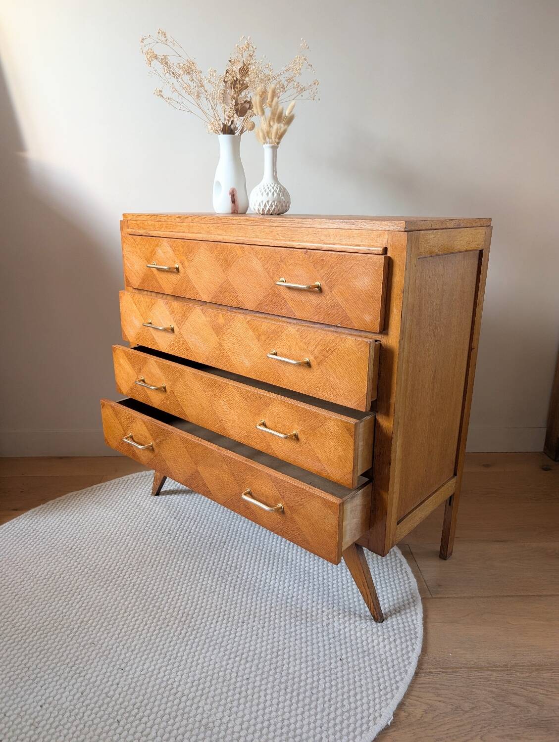 Vintage chest of drawers with checkerboard and compass feet