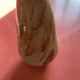 Large antique pottery bottle in glazed terracotta with drips.