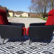 Pair of vintage armchairs in black faux leather and red fabric.