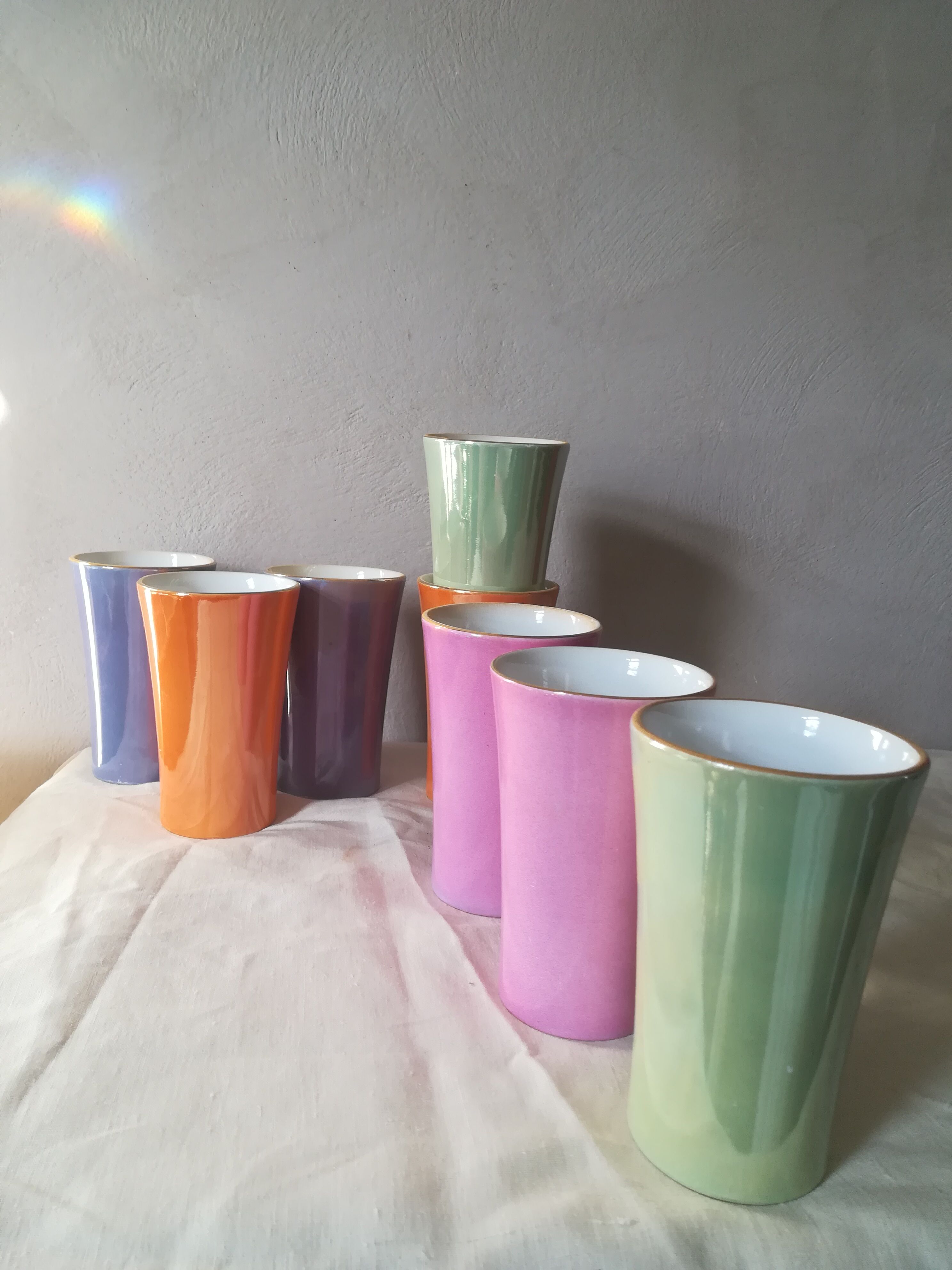 8 coloured cups in earthenware