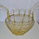 Old egg basket in yellow metal wire