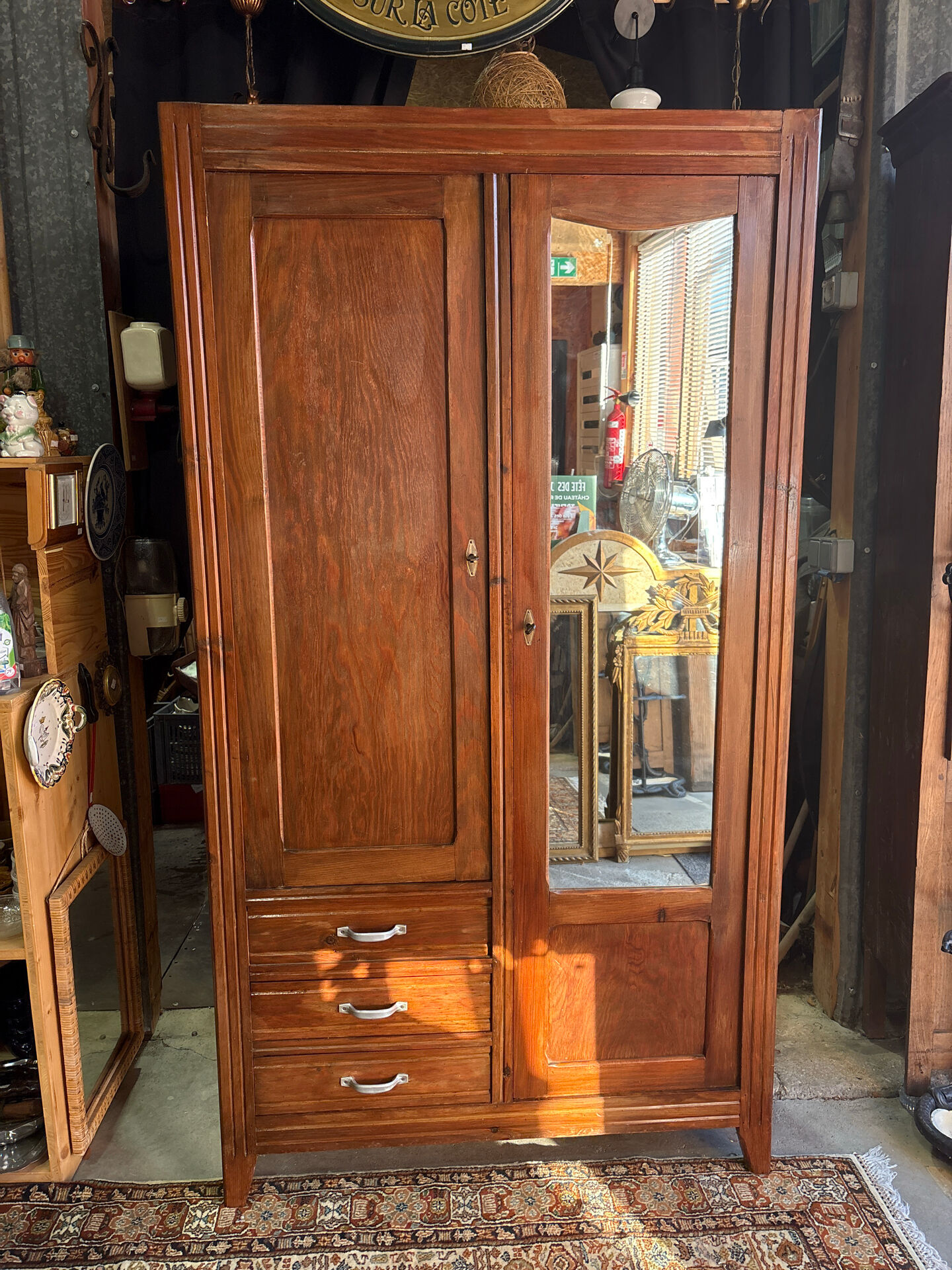 Antique Parisian wardrobe with mirror, hanging space and drawers.