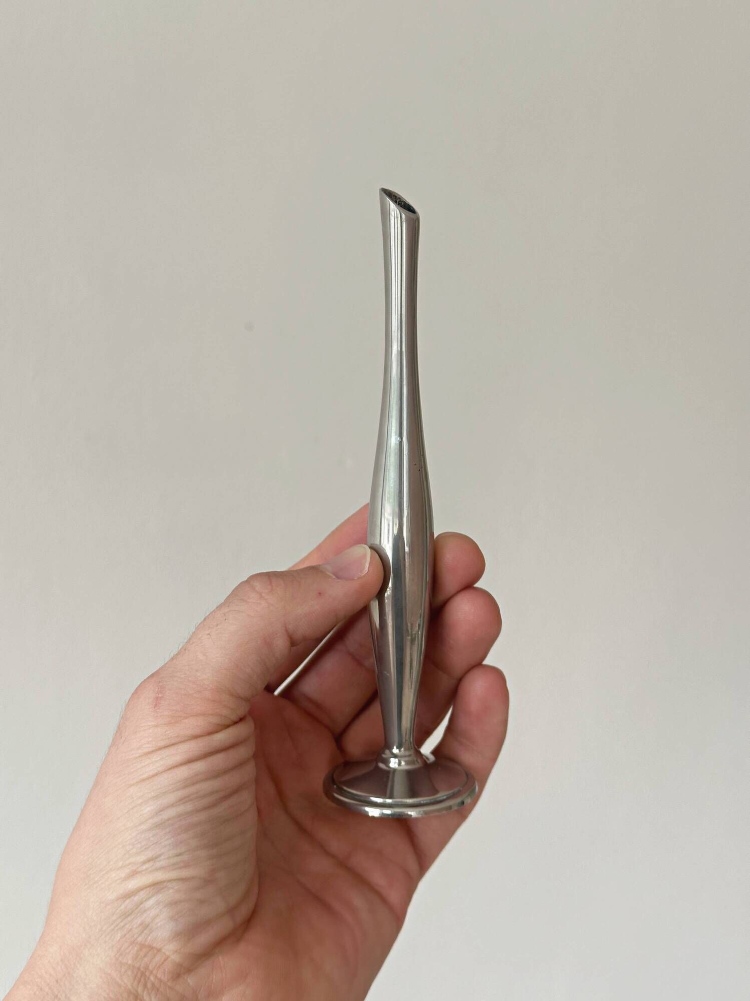 Set of three lightweight silver-coloured metal vases.