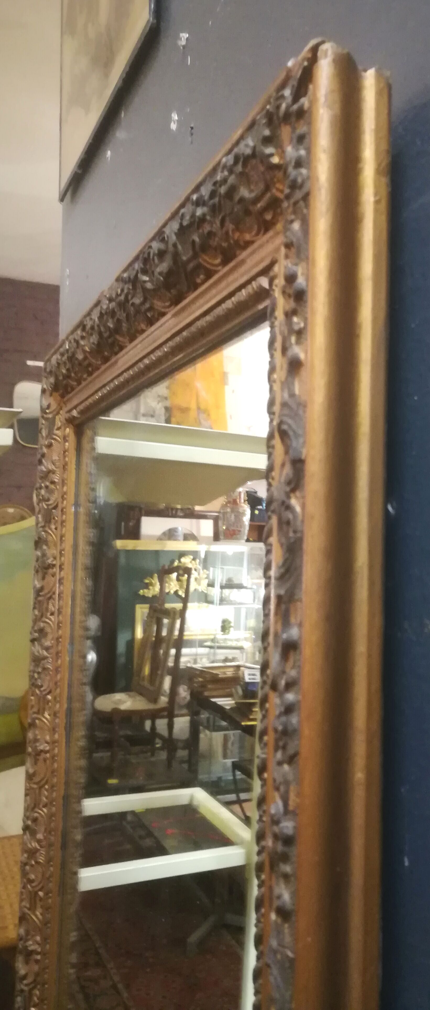 High and narrow mirror in gilded stucco late nineteenth century