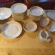 White and yellow porcelain dinner service with gold edging, Poral Limoges France