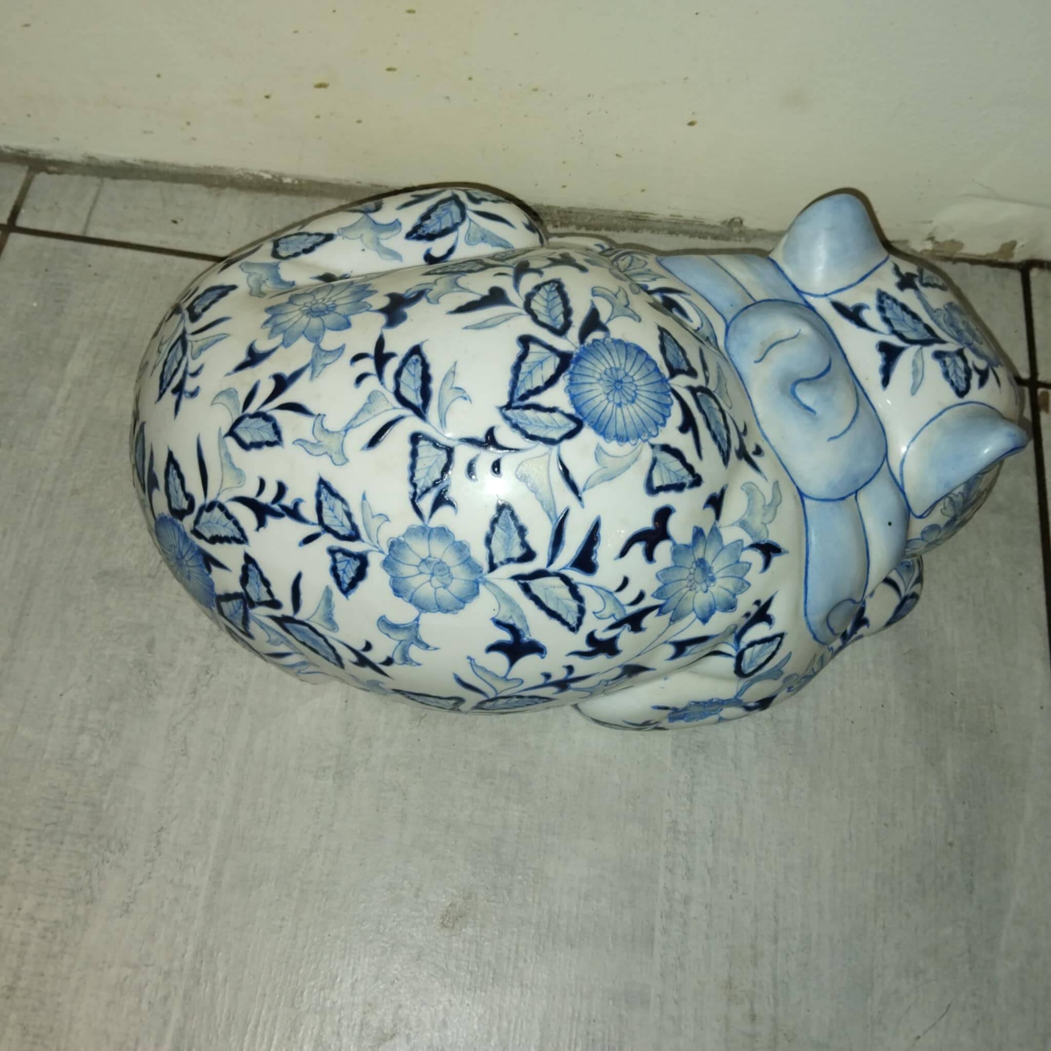 Vintage white and blue porcelain lying cat