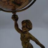Cherub or putti carrying a globe