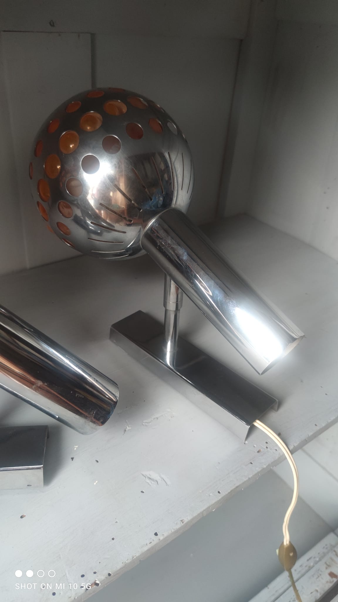 Pair of chrome-plated metal wall lights with adjustable ball joints, circa 1970