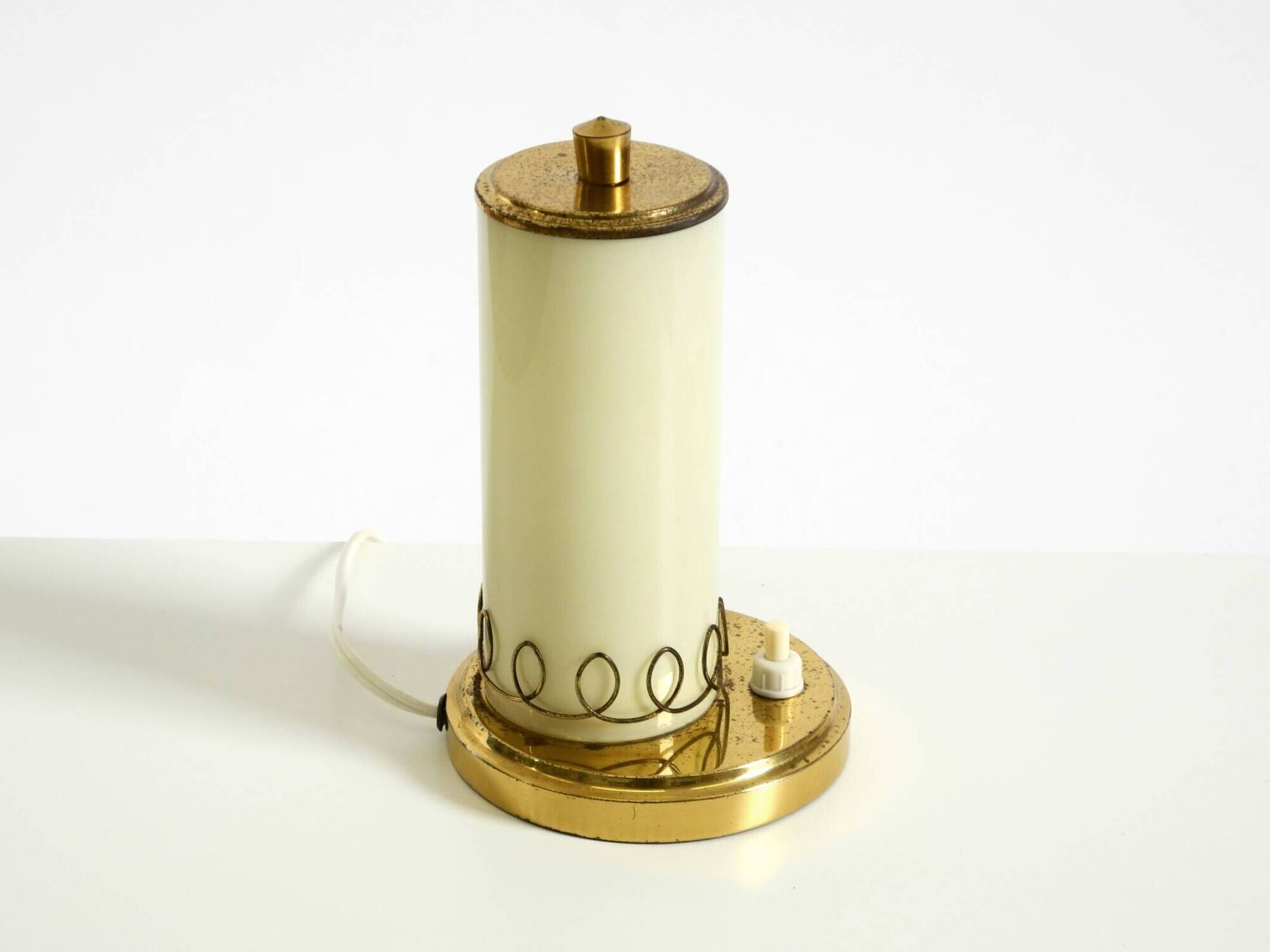 A beautiful, rare 1950s brass table lamp with one opal glass shade adorned