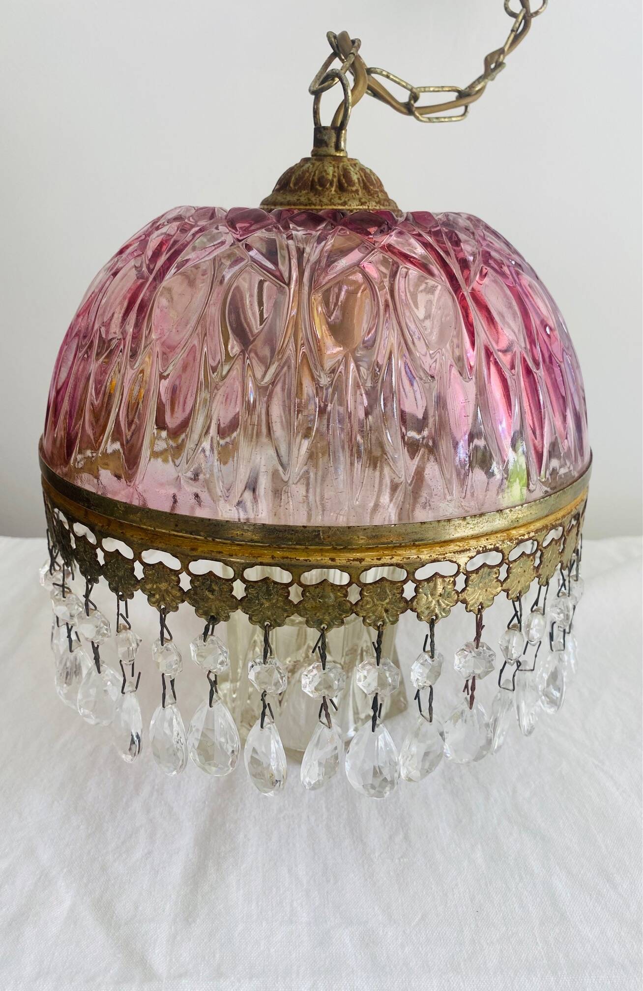 Antique pink glass pendant light with tassels.