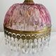 Antique pink glass pendant light with tassels.