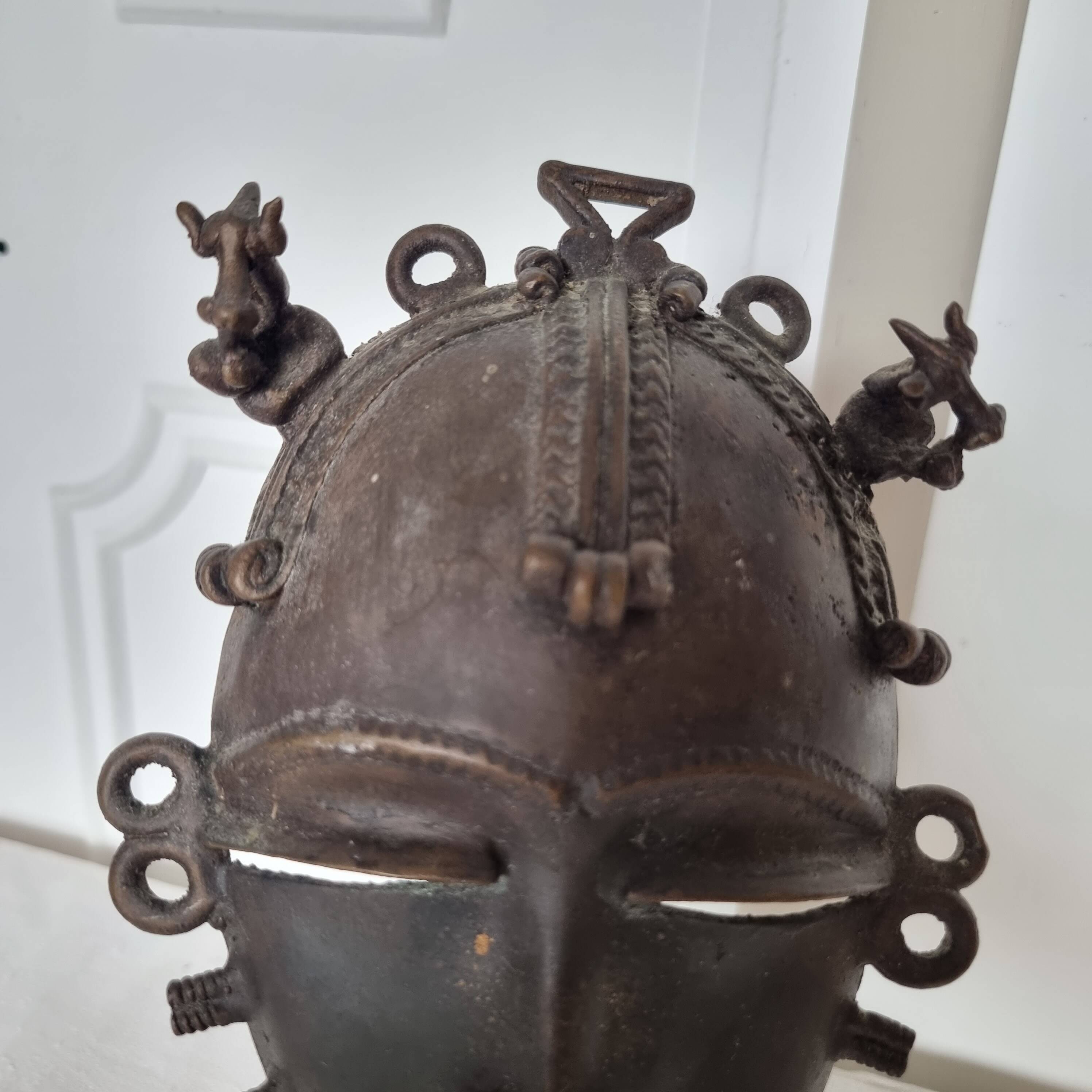 African bronze mask on pedestal, from Ivory Coast, dating