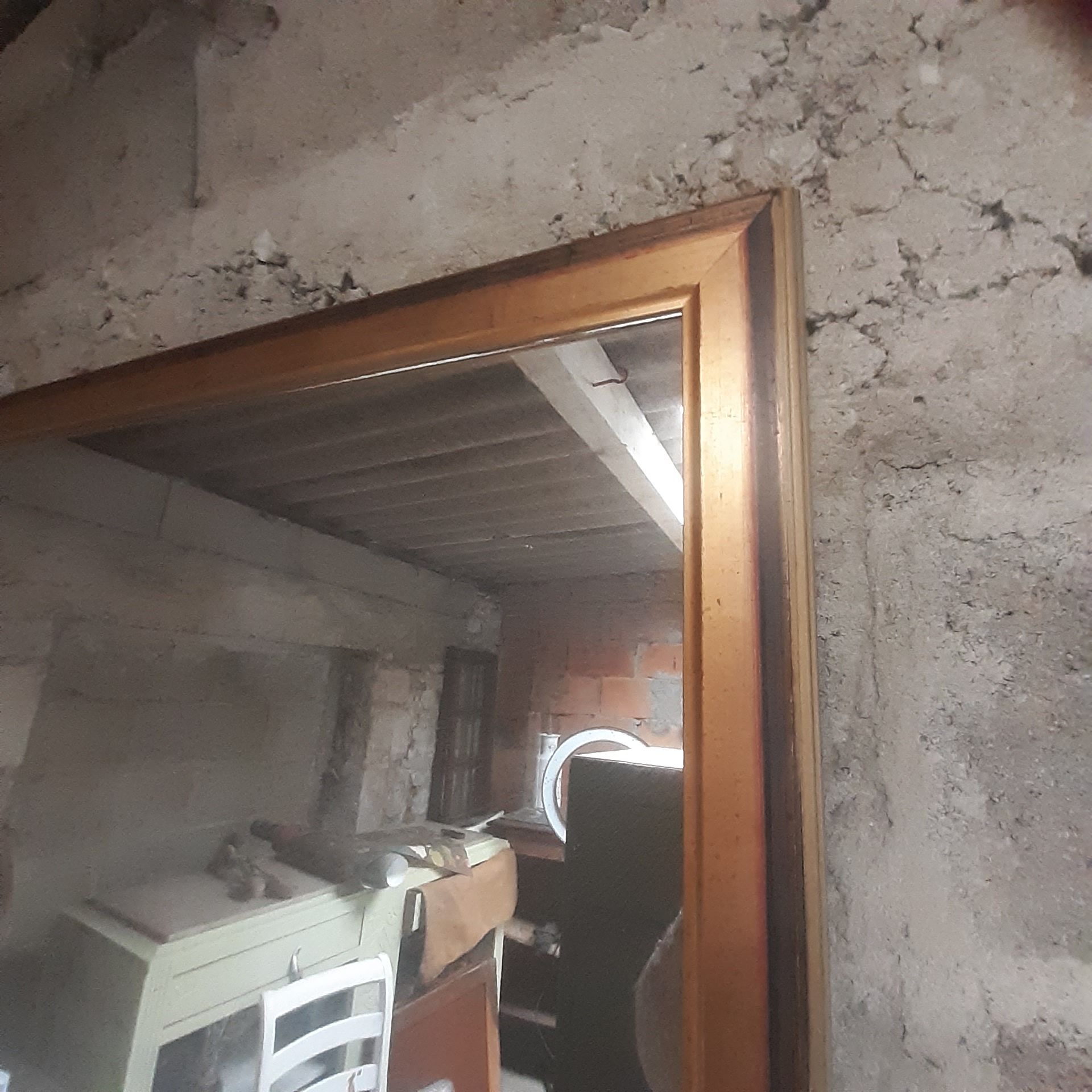 Old mirror of period handmade by cabinetmaking and decorated with gold leaf