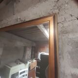 Old mirror of period handmade by cabinetmaking and decorated with gold leaf