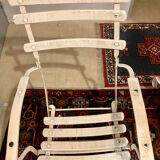 White armchair with wooden slats and metal structure
