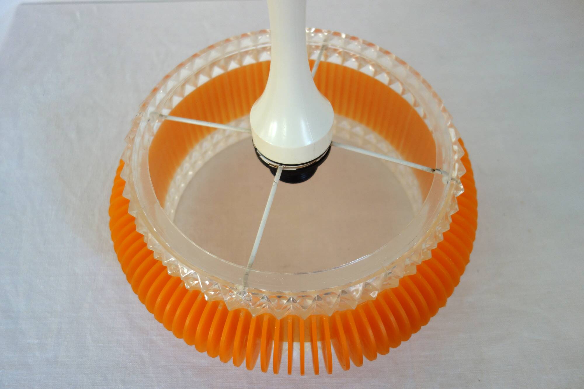 Transparent plastic space age lustre with orange band from the 70s.