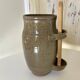 Old varnished stoneware pickle pot with tongs