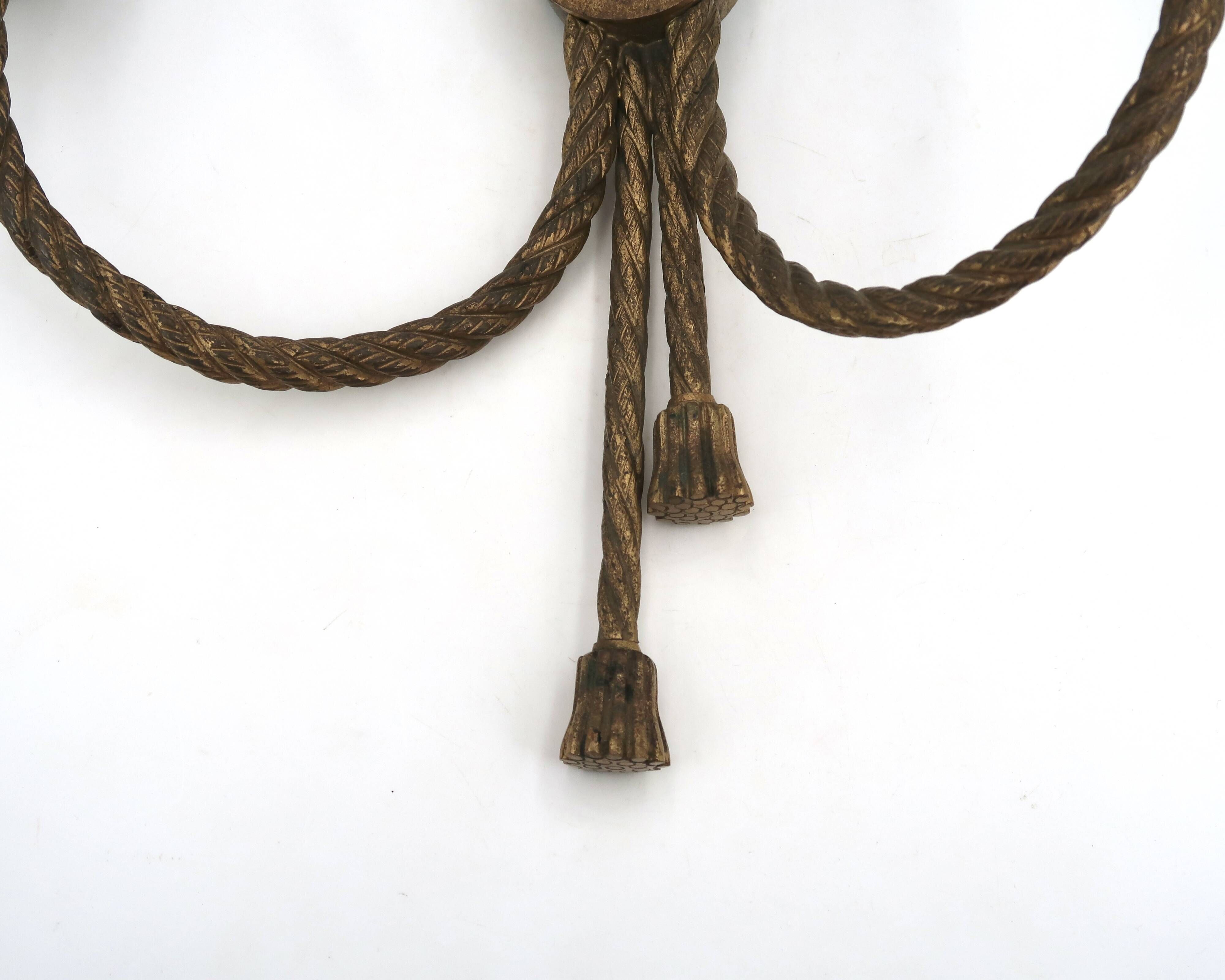 Golden wall lamp with two arms, decorated with a twisted rope bow, 1950s.