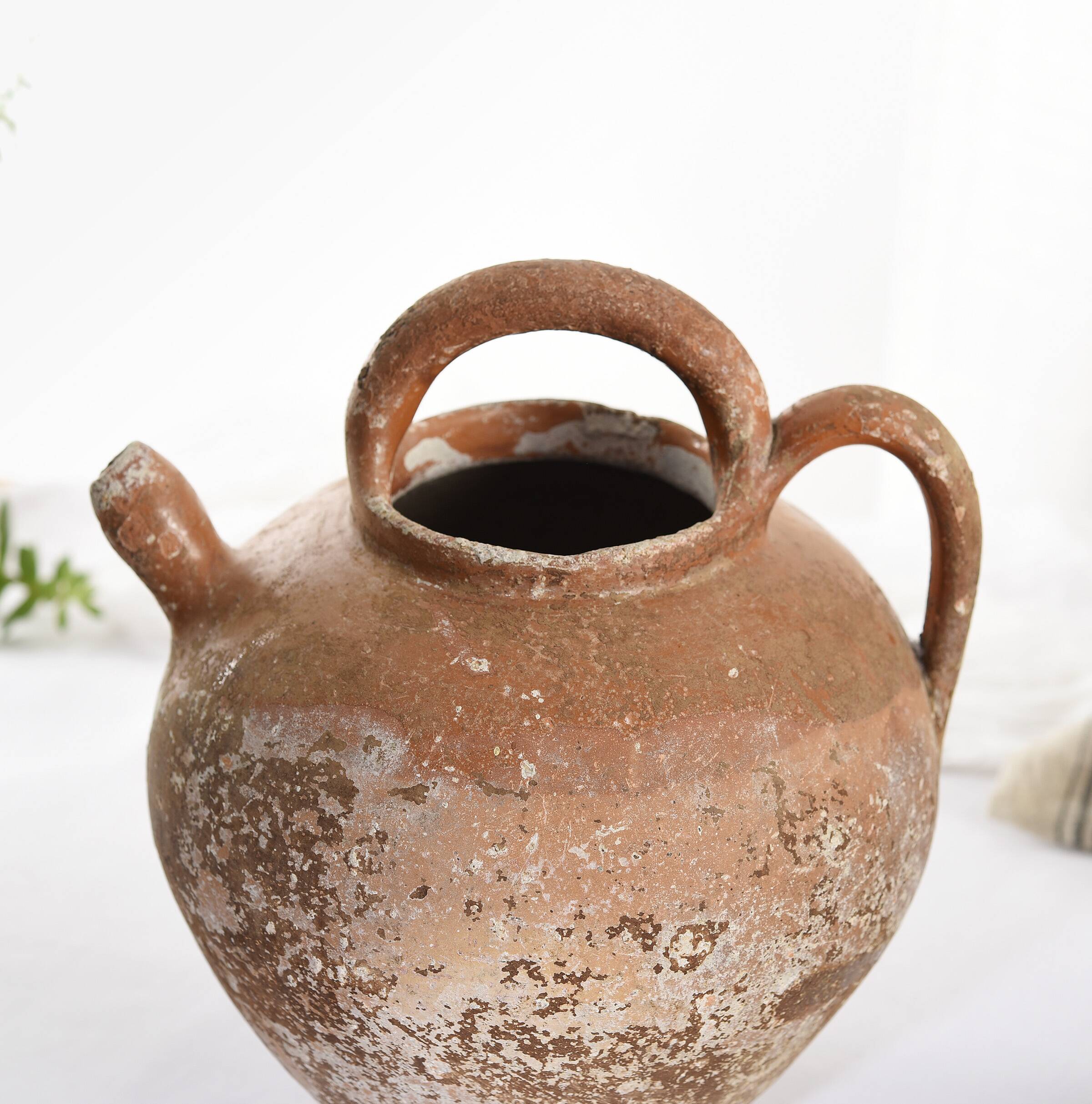 Old water jug. Gargoulette. Old terracotta pitcher.