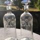 Two antique engraved glass bottles