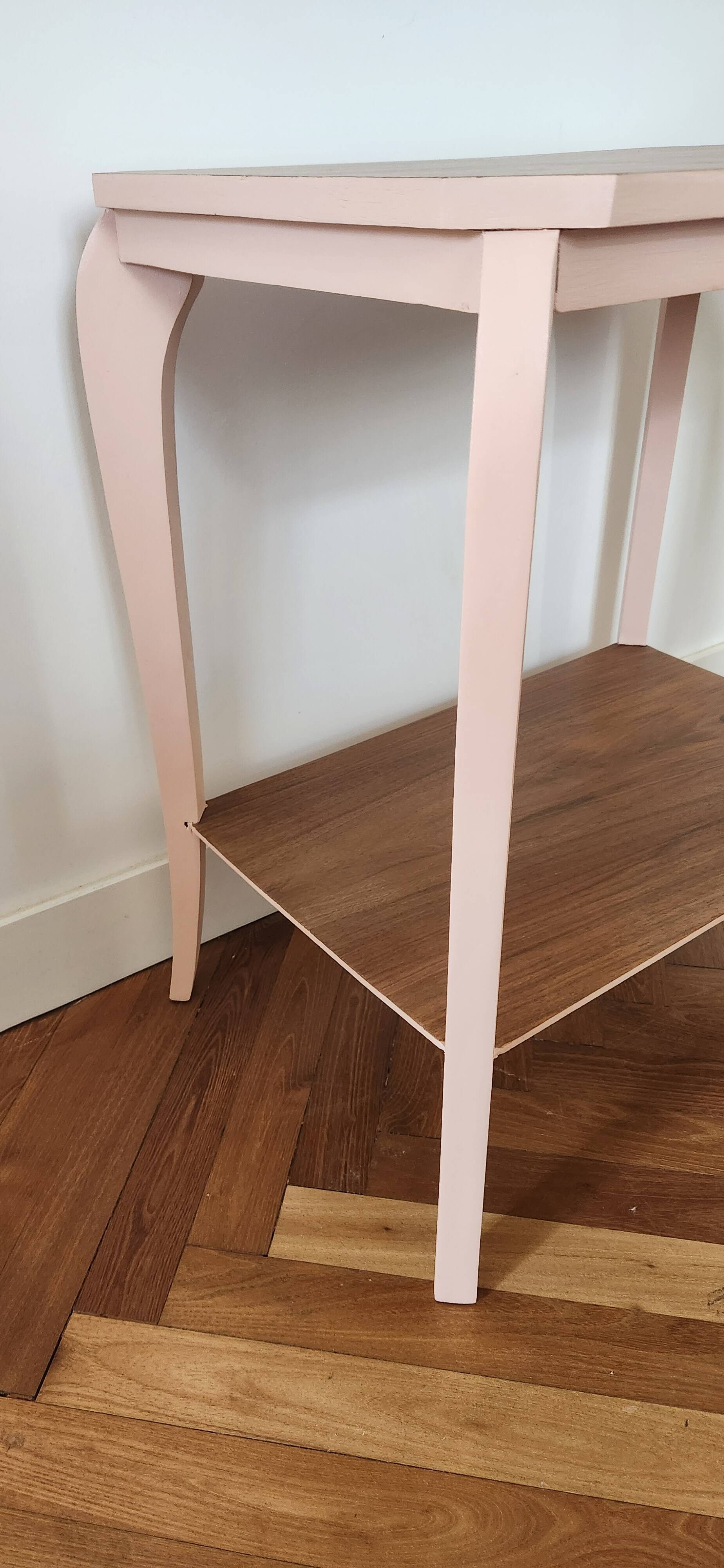 Side table with curved pink legs