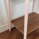 Side table with curved pink legs