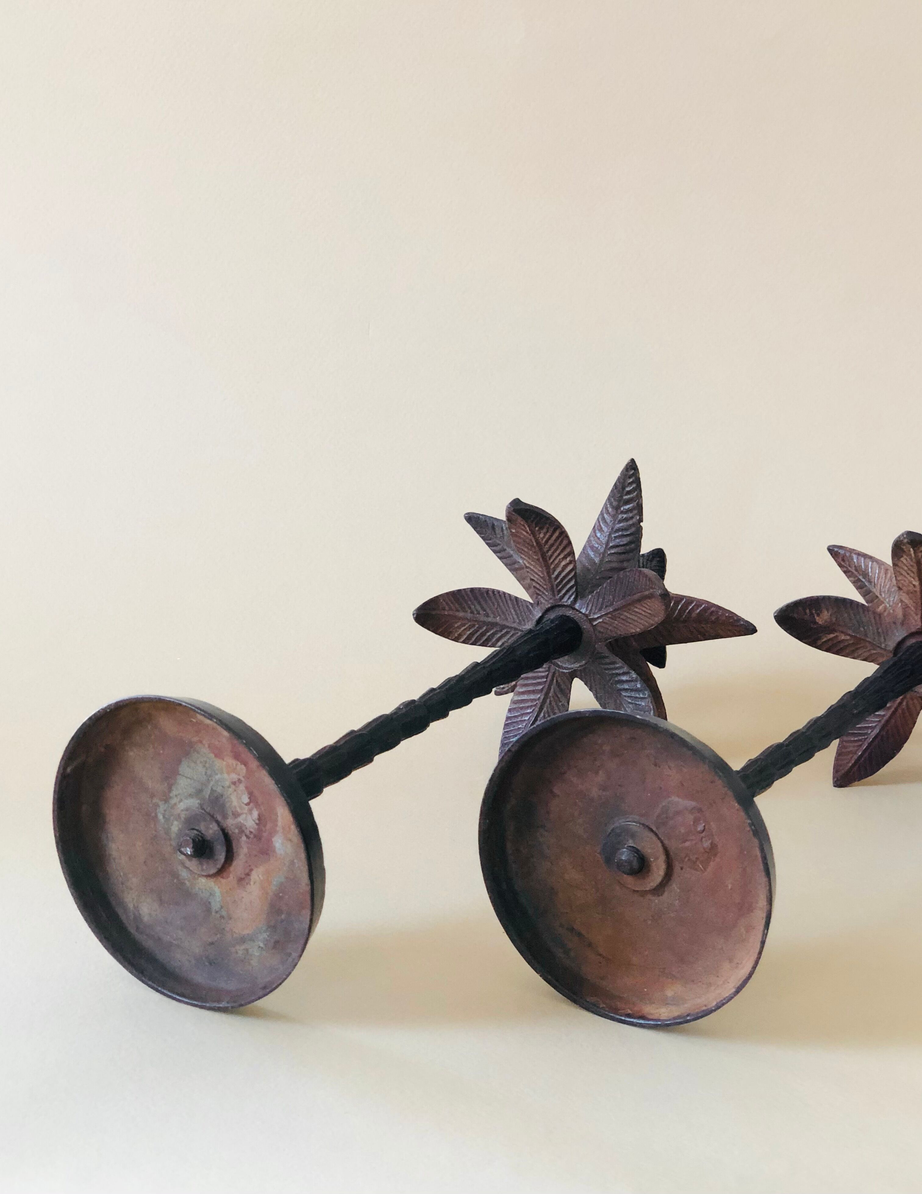 Pair of patinated metal candlesticks
