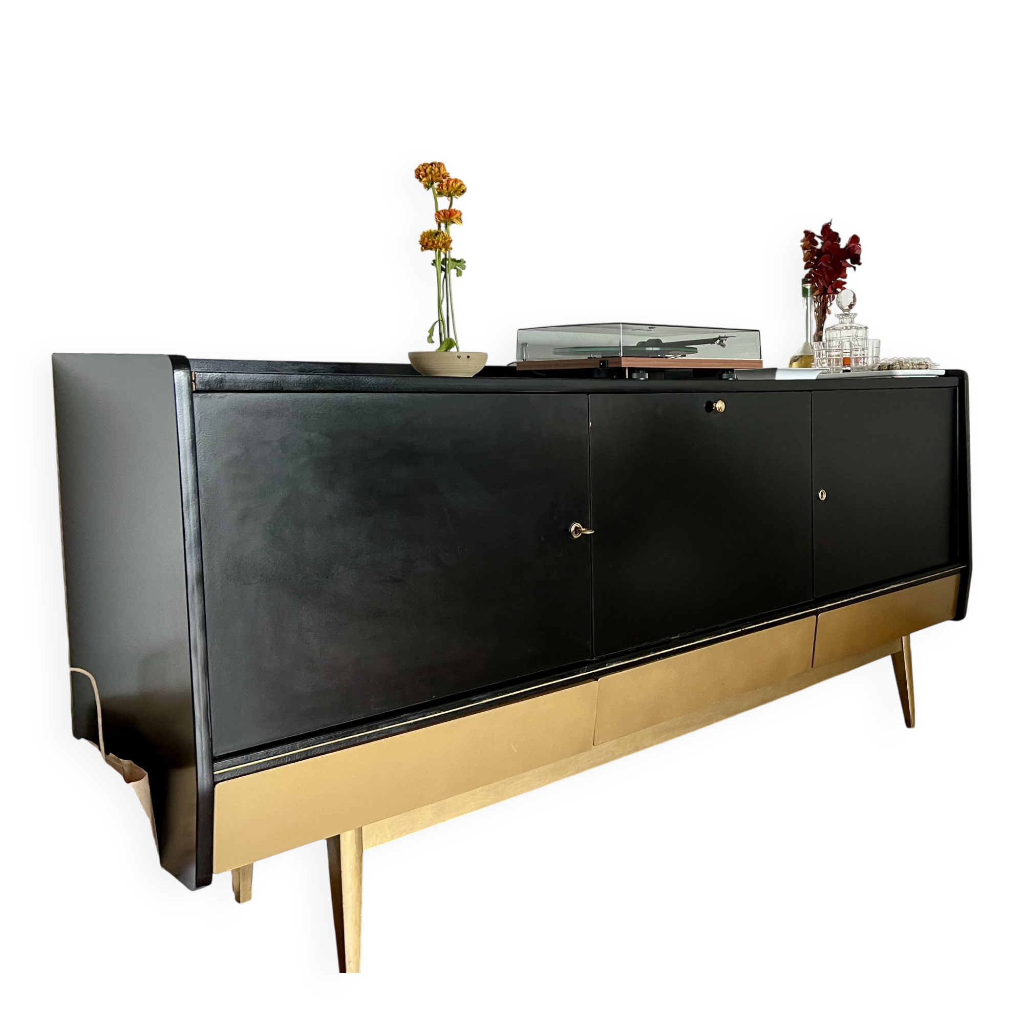 Black buffet cabinet including a bar and 3 drawers.