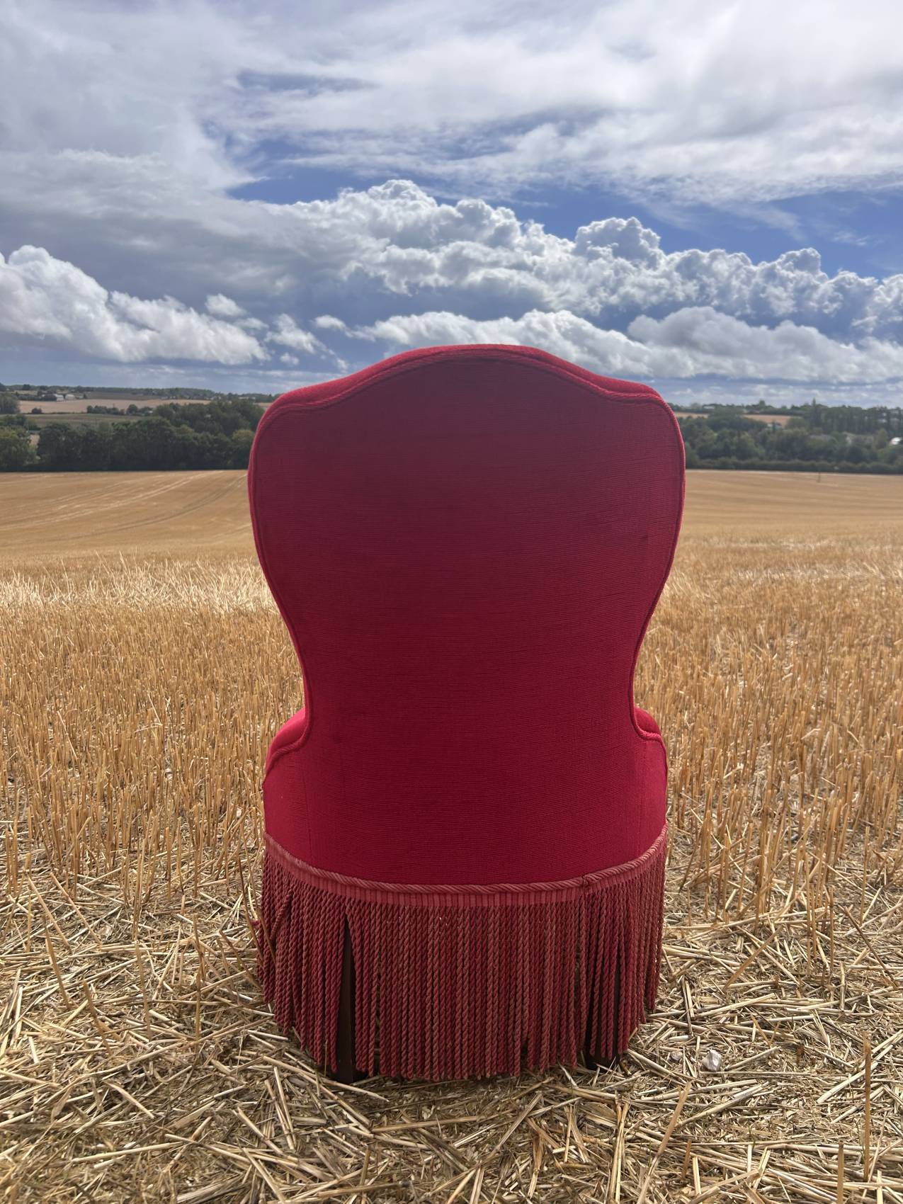 Vintage burgundy velvet armchair with fringes – theatrical and elegant