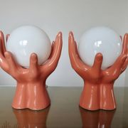 Pair of salmon-colored ceramic "hand" lamps with opaline globe, 80