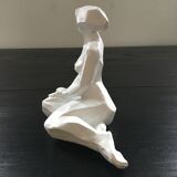 Statuette woman seated in plaster