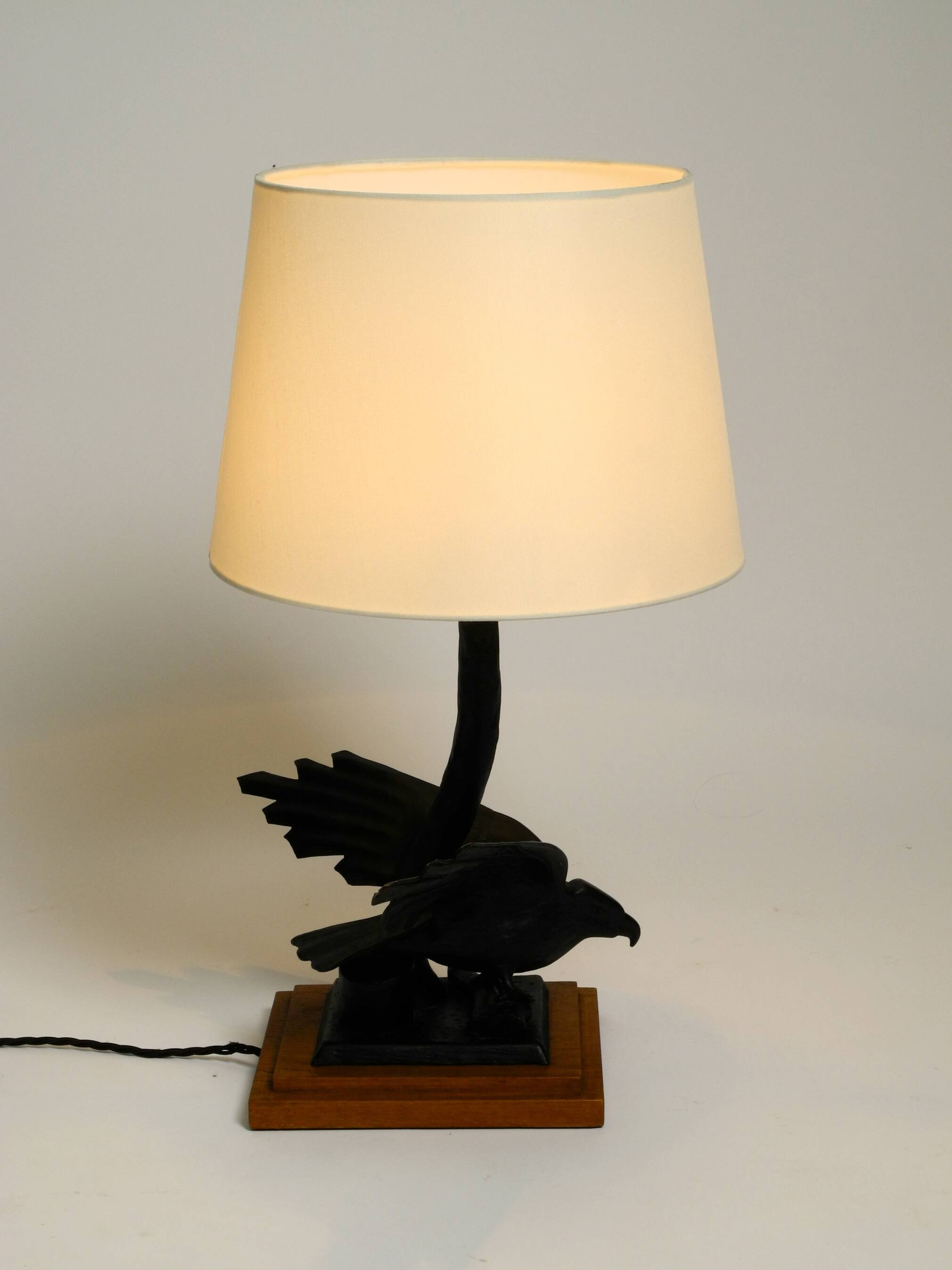 1940s table lamp made of iron in the shape of an eagle, teak wooden base