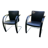 2 black cantilever armchairs