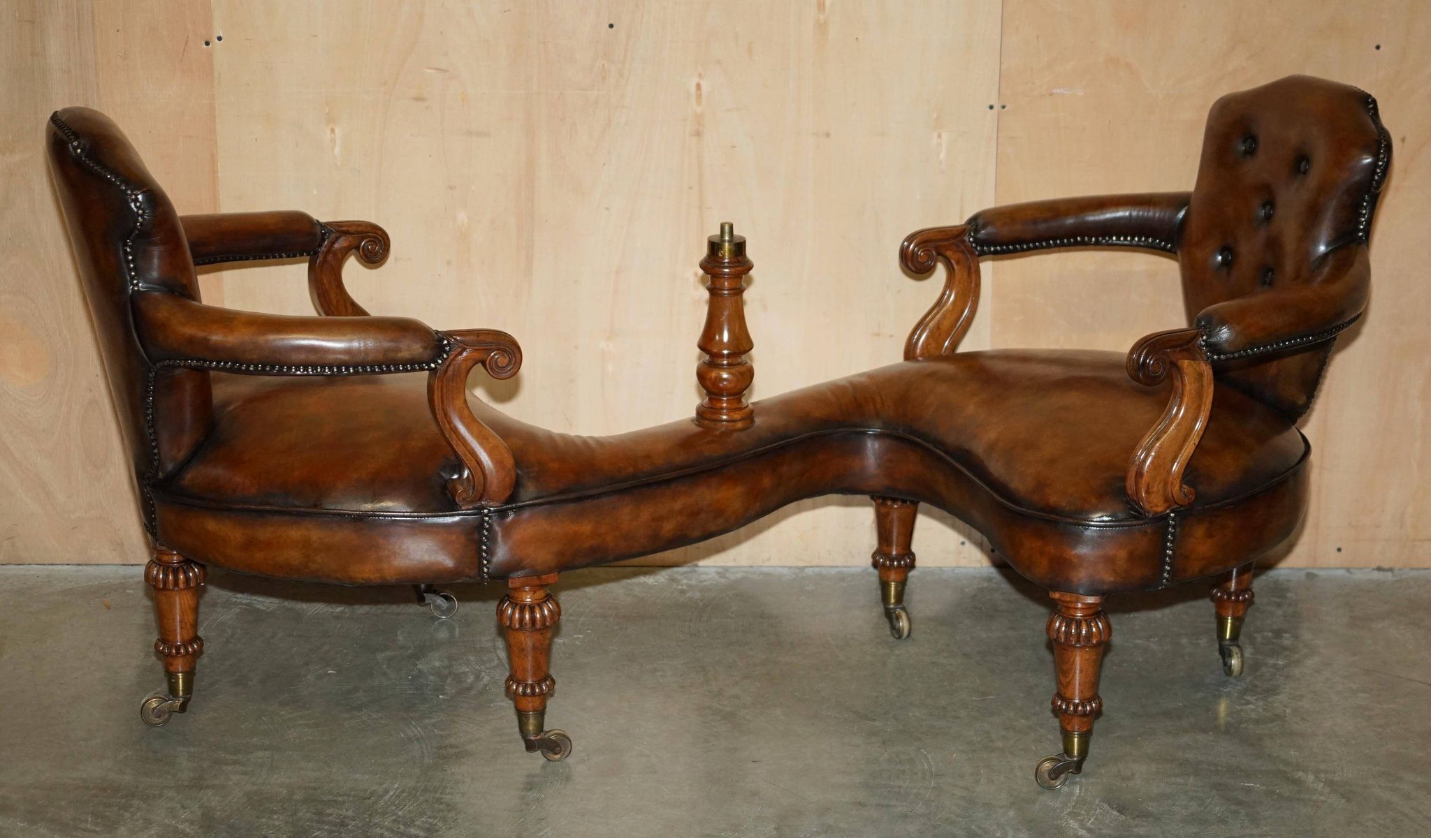 High Victorian leather tête-à-tête canapé with a walnut burr chessboard.