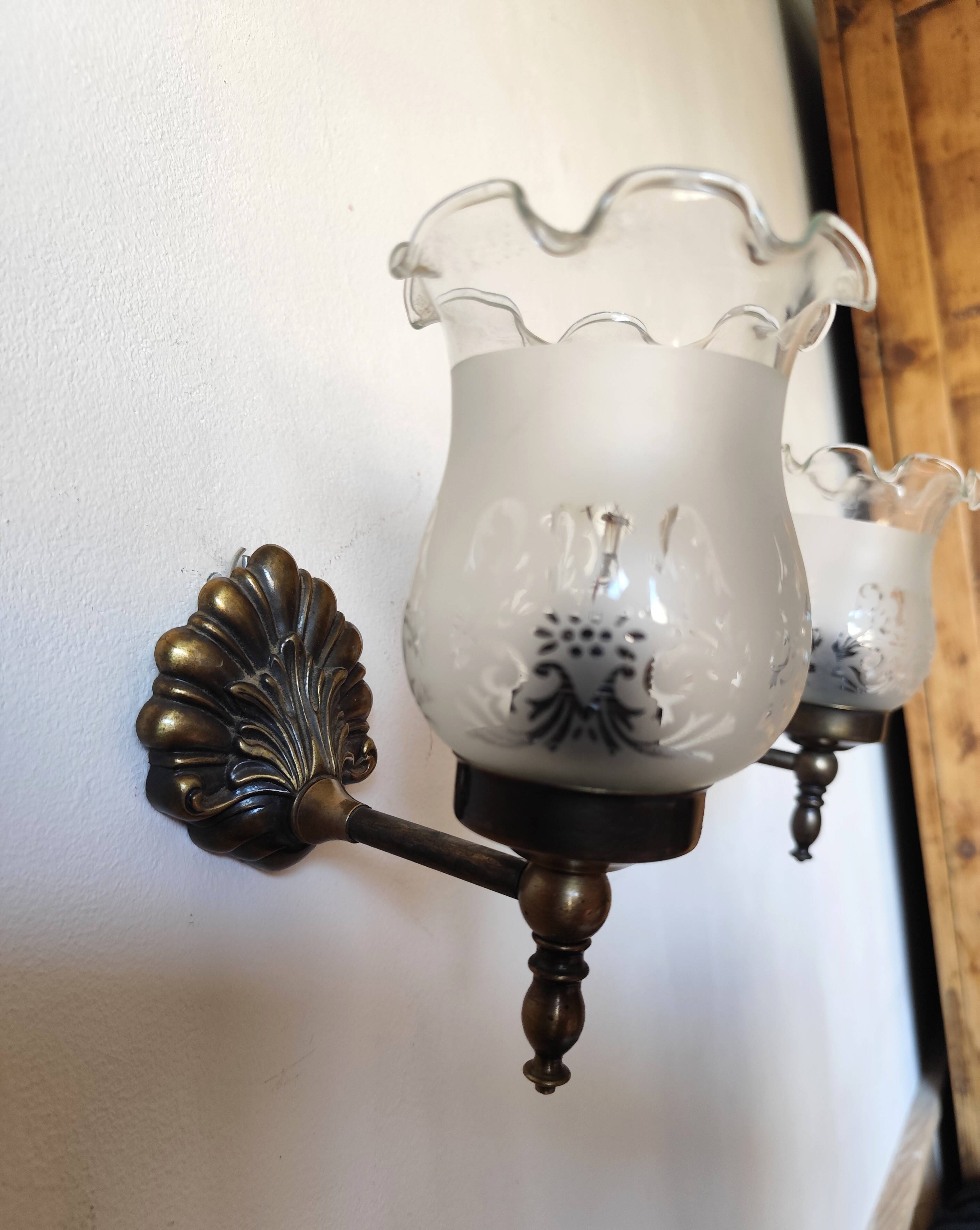 Pair of wall sconces in bronze with opaline glass tulips.