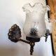 Pair of wall sconces in bronze with opaline glass tulips.