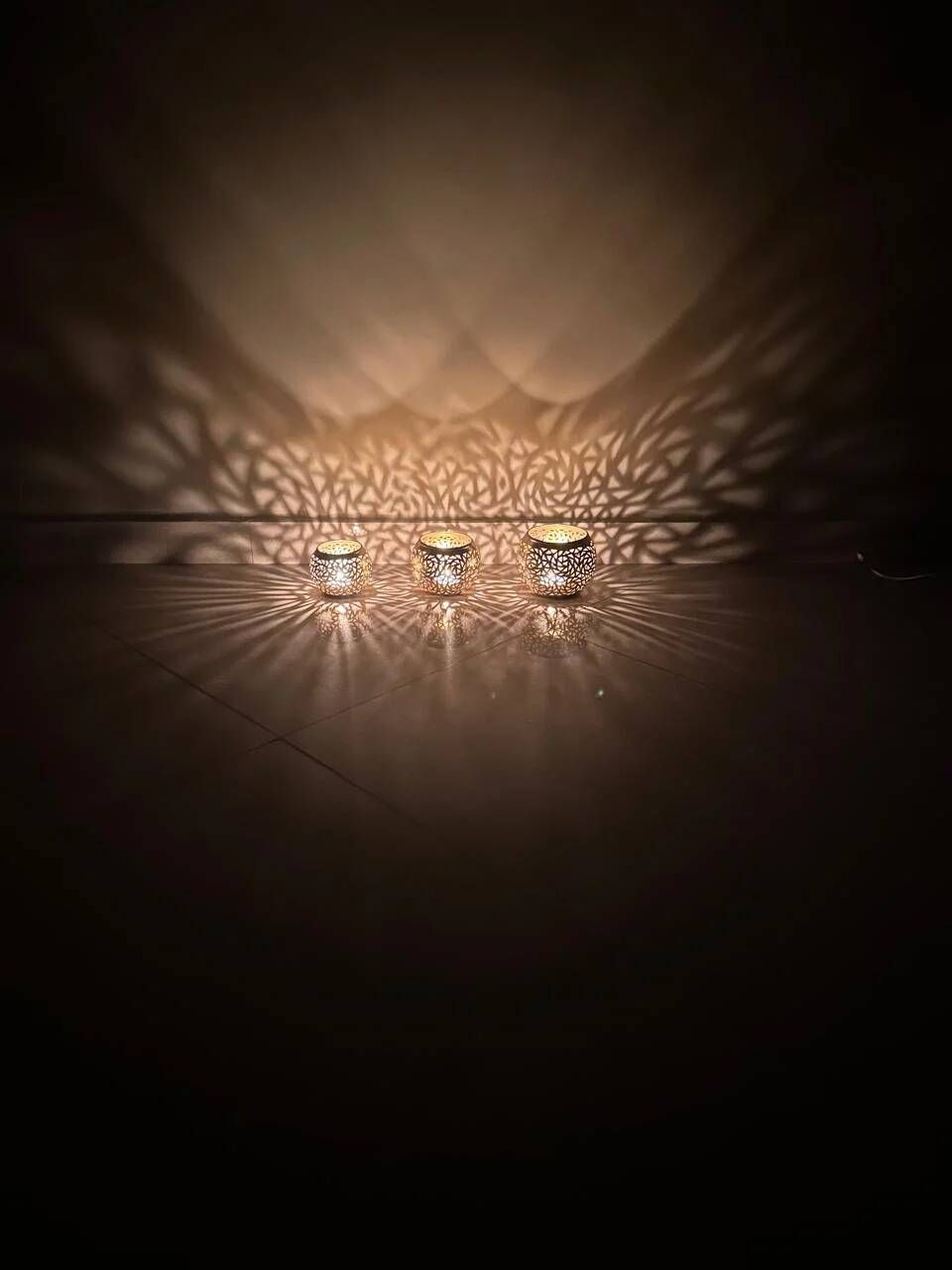 Set of 3 handmade brass candle holders with an openwork pattern.