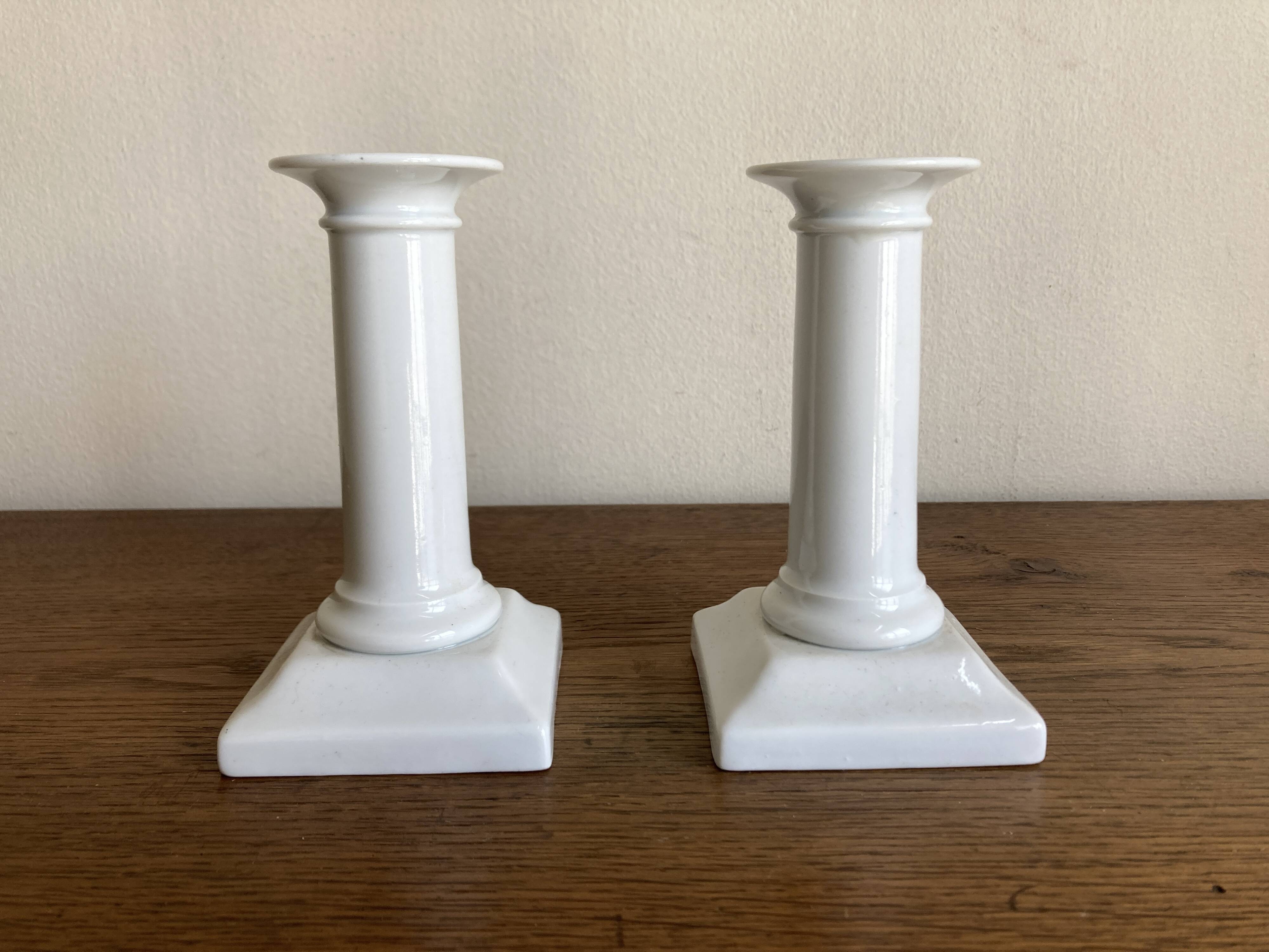 Pair of neo-classical Empire candlesticks from the late 19th century in white porcelain.