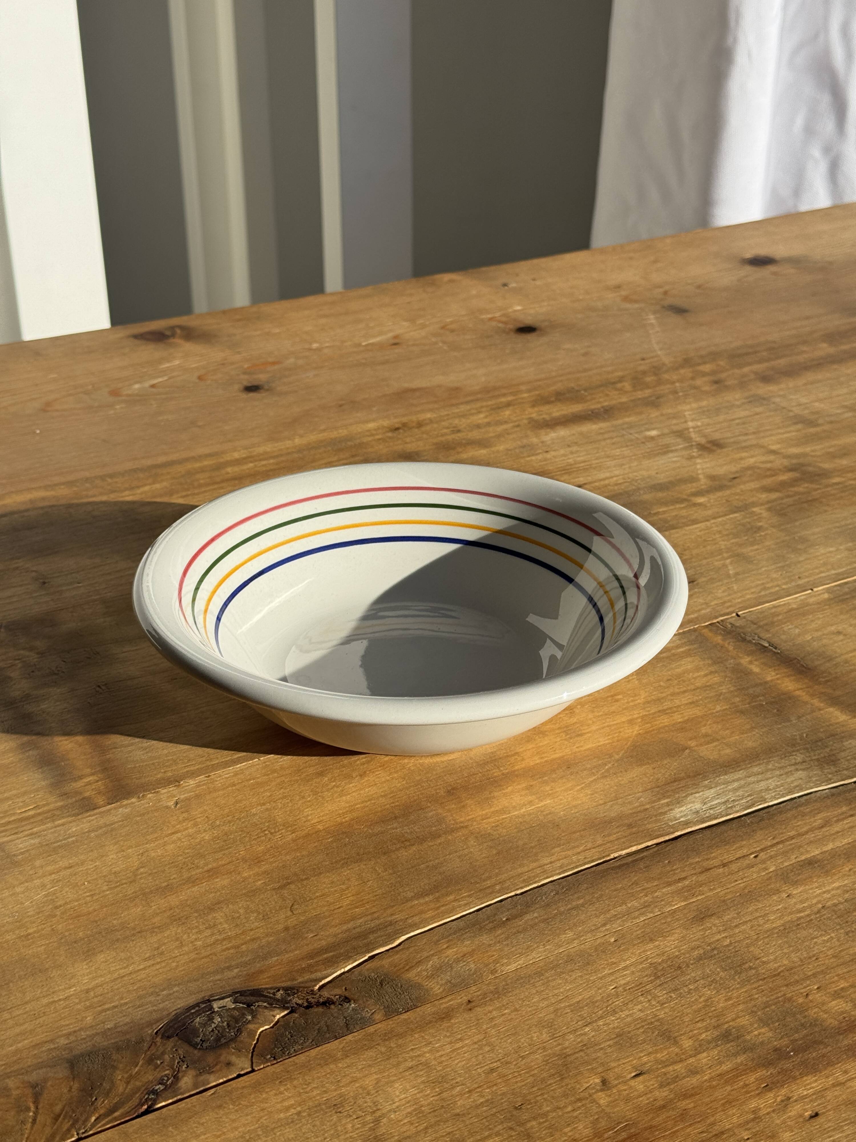 Small earthenware bowl from Italy, white with brown, green, and orange trim, D24.5.